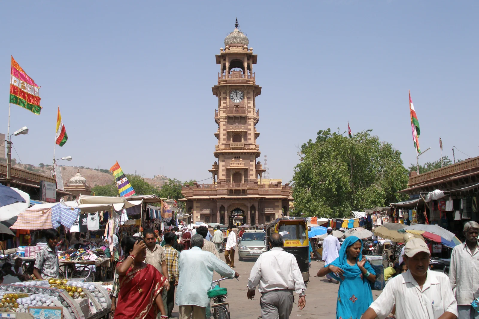 Ghanta Ghar clock tower rising over shoppers and stalls in central Jodhpur.