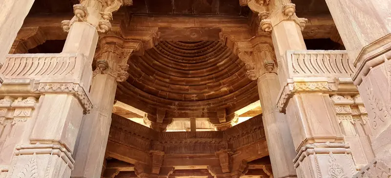Sunlit carved sandstone pavilion at Mandore Gardens near Jodhpur.