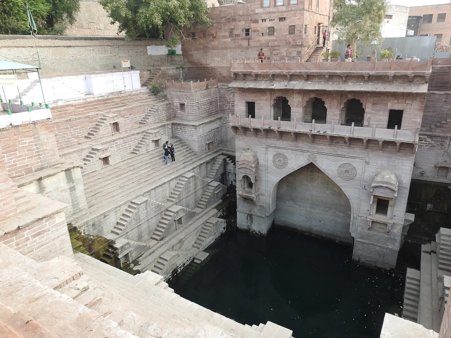 Geometric sandstone steps descending to the water at Toorji Ka Jhalra.